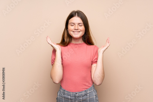 Ukrainian teenager girl over isolated background laughing