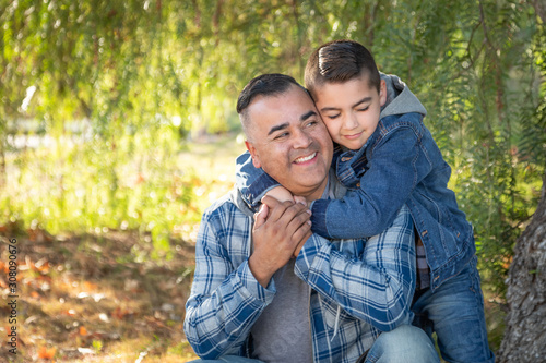 фотографія Portrait of Mixed Race Father And Son Having Fun Outdoors