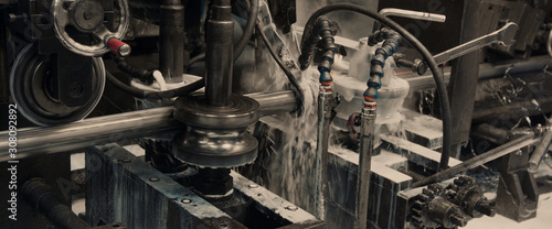 Steel cog gear set of metal sheet bending machine in metalwork factory.