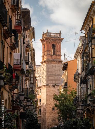 Obraz na płótnie Typical street of Valencia with a historic tower in the background, Spain w salonie