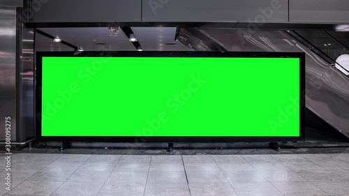 Empty blank widescreen billboard with green screen, alpha channel. Chroma key frame on airport hall, big banner for marketing. 