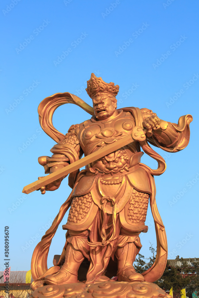 outdoor Chinese buddha golden color figure in blue sky