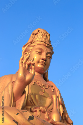 outdoor golden color Buddha figure closeup day view