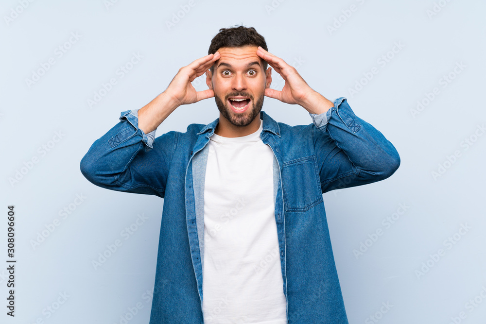Handsome man over isolated blue background with surprise expression Handsome man over isolated blue background with surprise expression