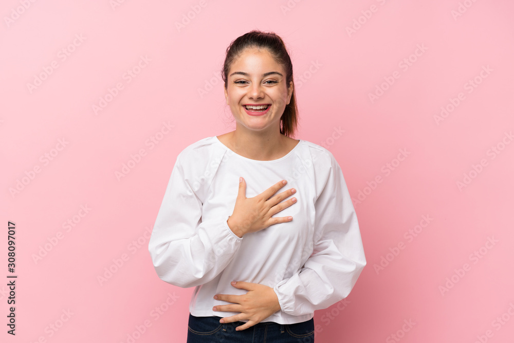 Young brunette girl over isolated pink background smiling a lot Young brunette girl over isolated pink background smiling a lot