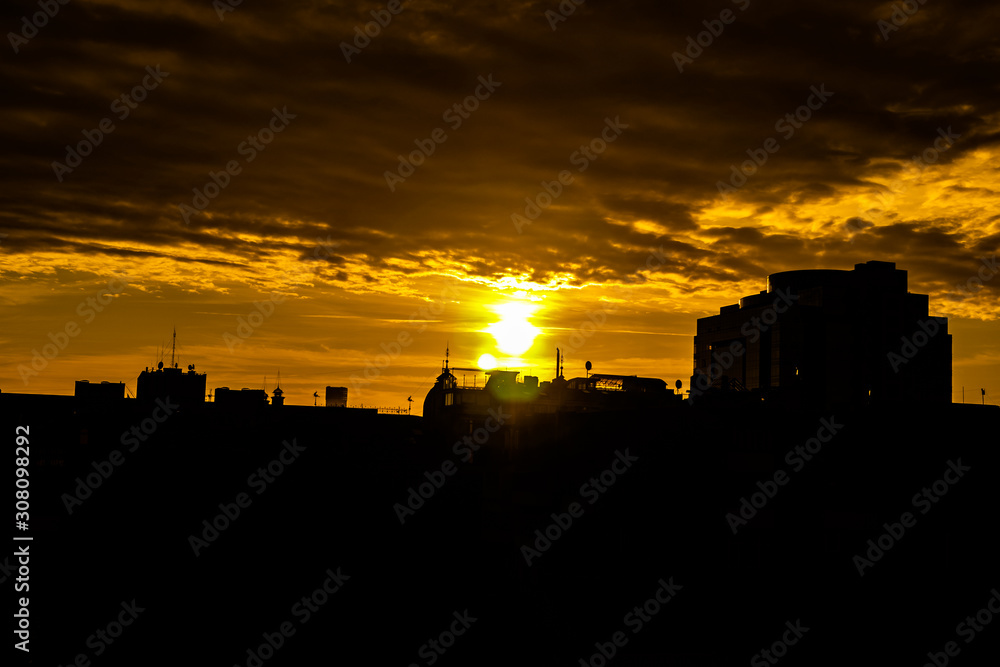 Dramatic sunset over the evening city. stock photo 