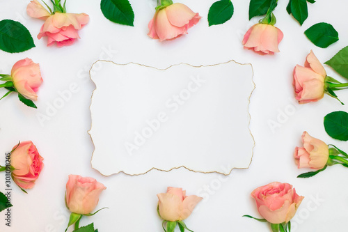 Floral frame composition with pastel roses and white paper vintage card