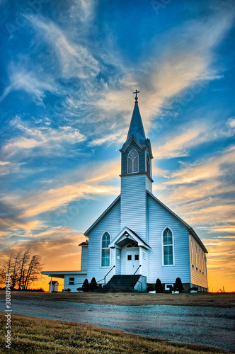 Ellis County, KS USA - A Lone Wooden Church at Dusk with Sunset Clouds in Kansas American Midwest Prairie