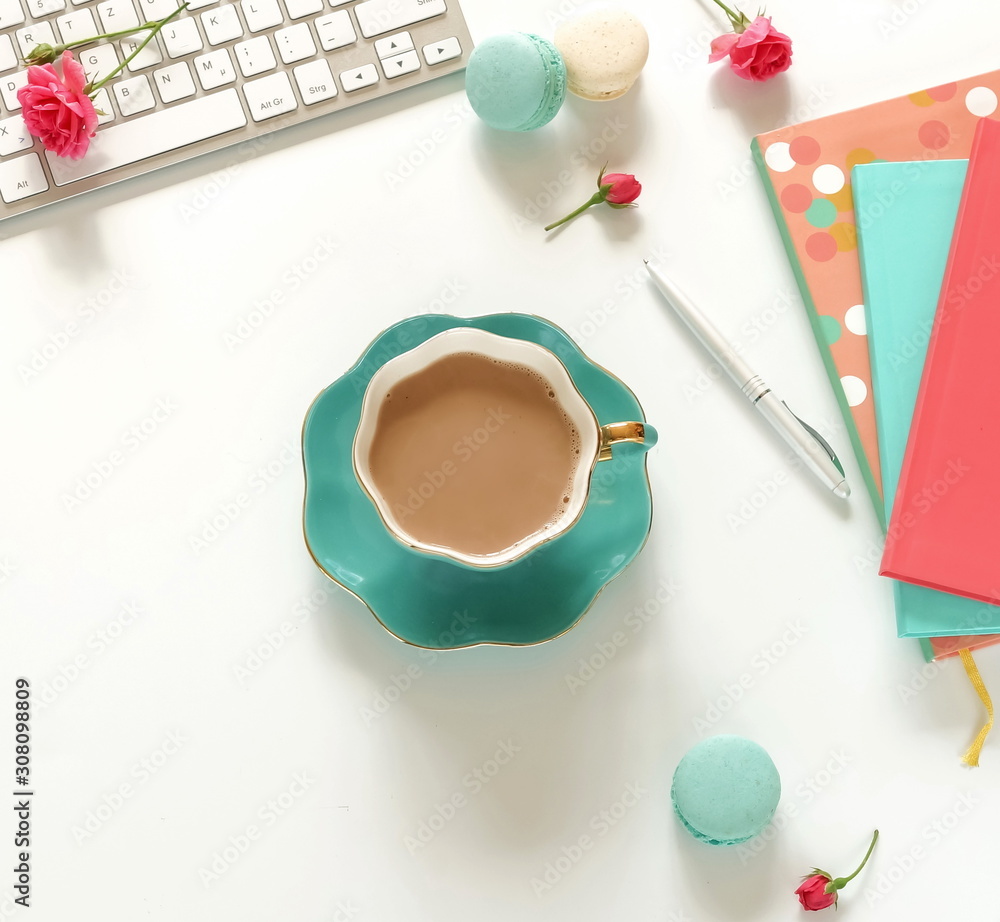 Flat lay women's office desk. Female workspace with laptop, flowers roses, accessories, notebooks, cup of coffee on white background. Top view feminine background. Flat lay women's office desk. Female workspace with laptop, flowers roses, accessories, notebooks, cup of coffee on white background. Top view feminine background.