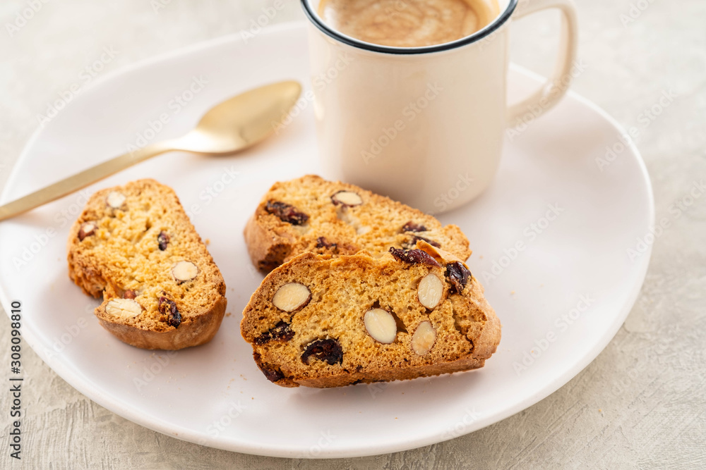Italian biscotti cookies with a cup of coffee on a light background. Italian biscotti cookies with a cup of coffee on a light background.