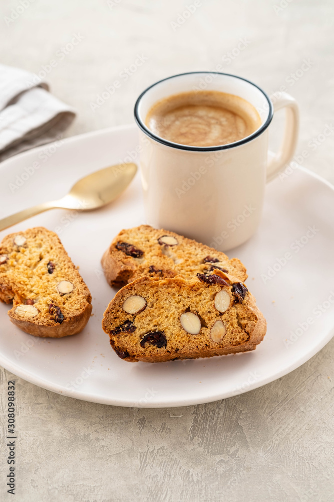 Italian biscotti cookies with a cup of coffee on a light background. Italian biscotti cookies with a cup of coffee on a light background.