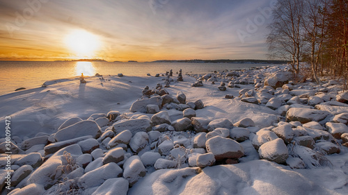 Obraz na plátně stone pyramids in the snow on the shore of Lake Ladoga in Karelia on a sunny win