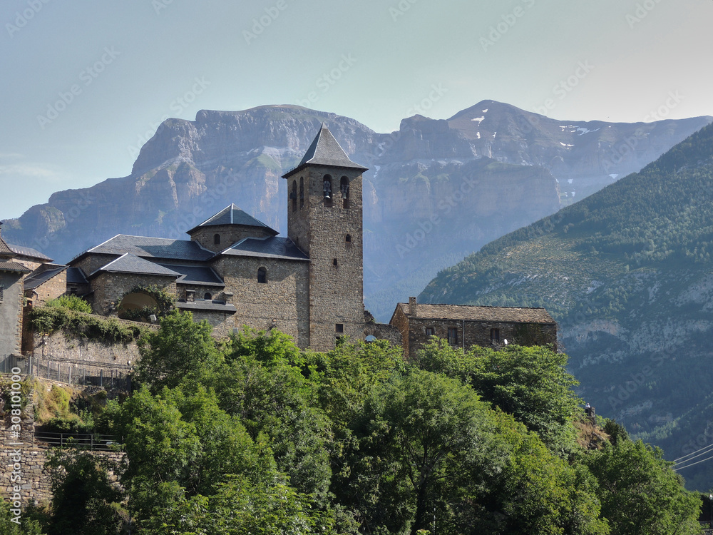 The Church of Torla and the walls of Mondarruego in the National Park of Ordesa and Monte Perdido in the Pyrenees of the province of Huesca. Aragon. Spain