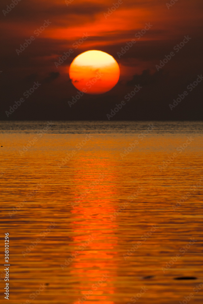 Sun setting on the sea horizon.