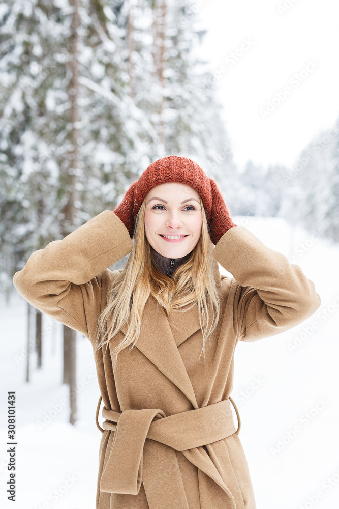 Beautiful girl, confident look into the future, pastel clothes, charming smile, blonde, long hair, background of snow-covered trees, fir trees Beautiful girl, confident look into the future, pastel clothes, charming smile, blonde, long hair, background of snow-covered trees, fir trees
