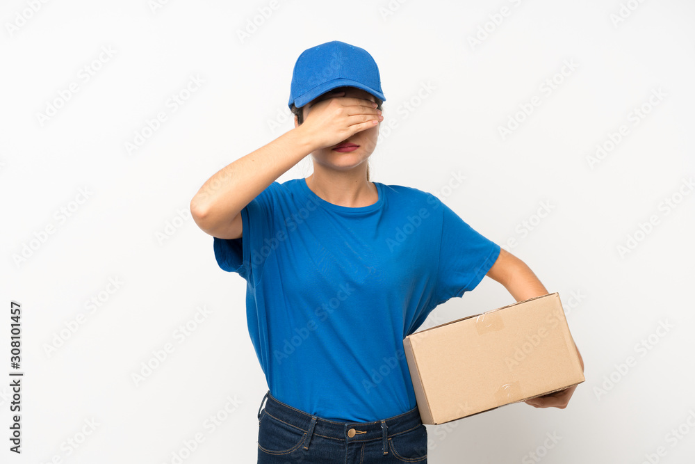 Young delivery girl over isolated white background covering eyes by hands Young delivery girl over isolated white background covering eyes by hands