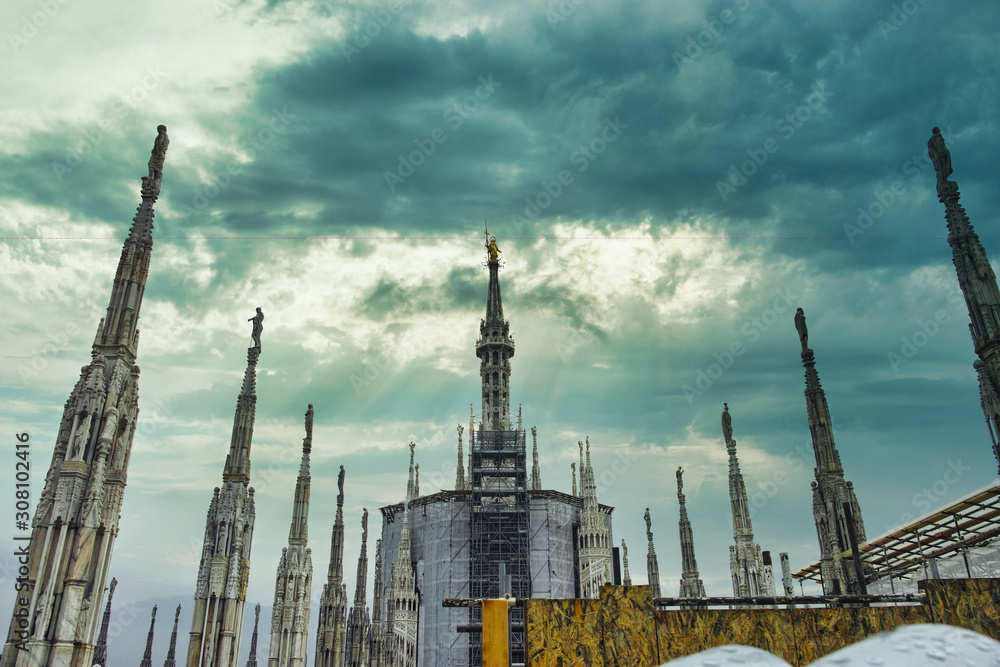 looking Duomo di Milano meaning Milan Cathedral in Italy, with blue sky