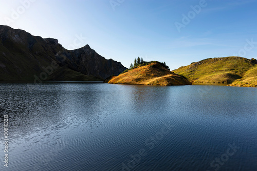 Idyllic mountain lake Schrecksee in late afternoon (Allgaeu Alps, Bavaria, Germany). Colorful alpine landscape with strong contrast and blue sky