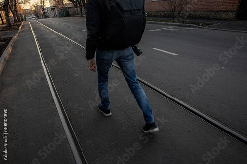 A photographer walking on old rail tracks