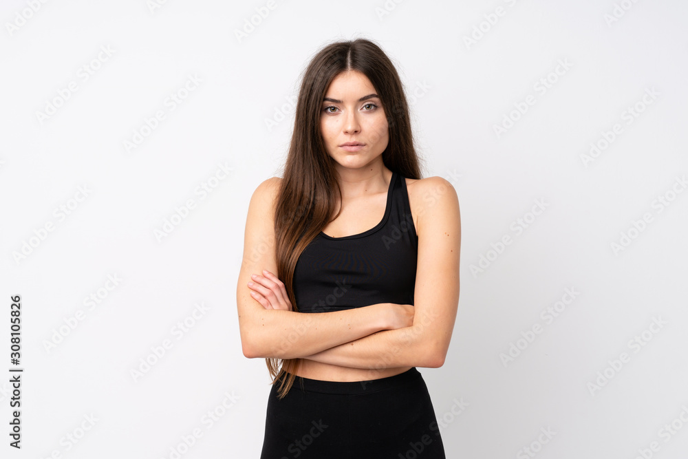 Young sport woman over isolated white background with arms crossed Young sport woman over isolated white background with arms crossed