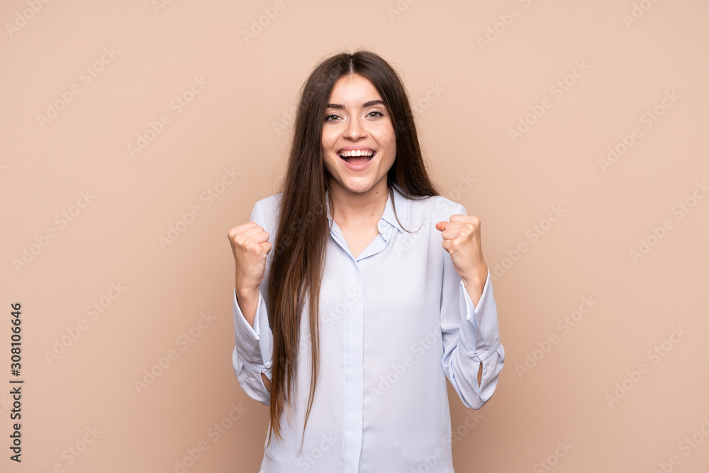 Young woman over isolated background celebrating a victory in winner position Young woman over isolated background celebrating a victory in winner position