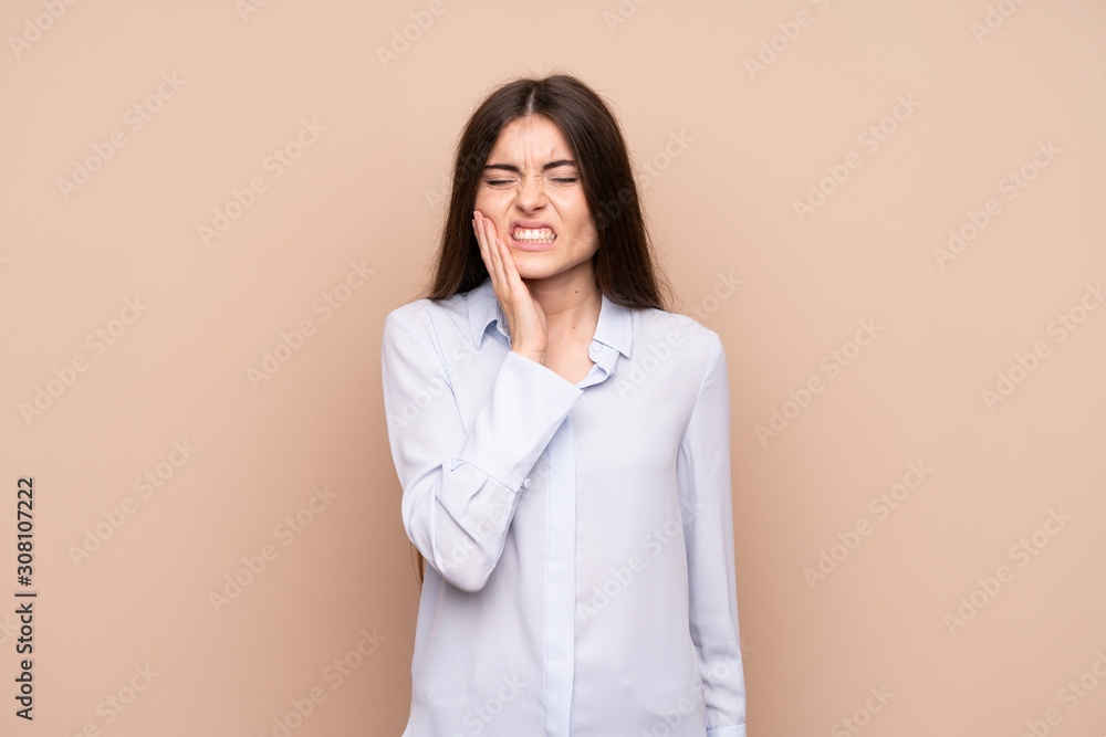Young woman over isolated background with toothache Young woman over isolated background with toothache