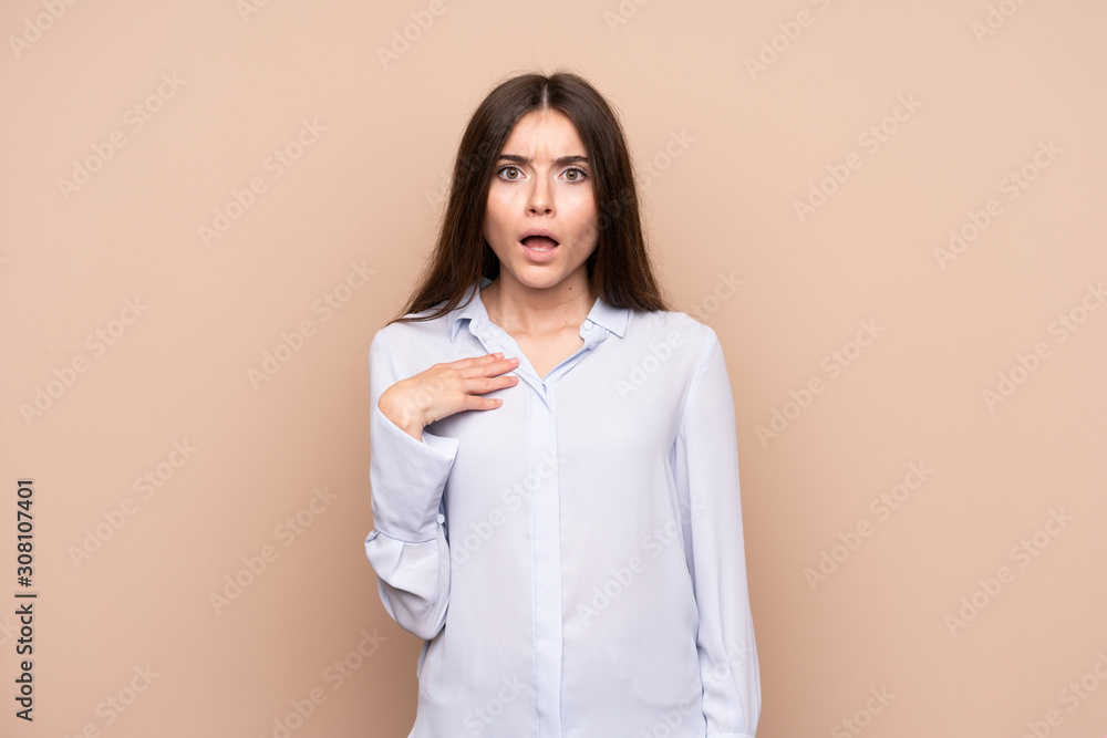 Young woman over isolated background surprised and shocked while looking right Young woman over isolated background surprised and shocked while looking right