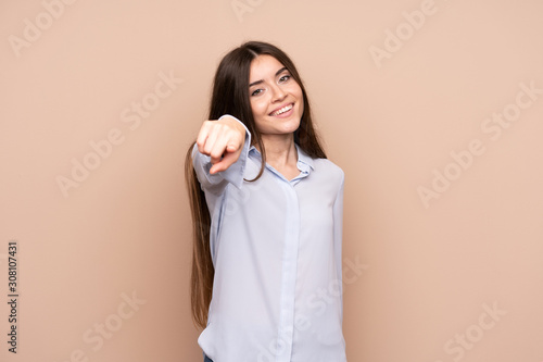 Young woman over isolated background points finger at you with a confident expression