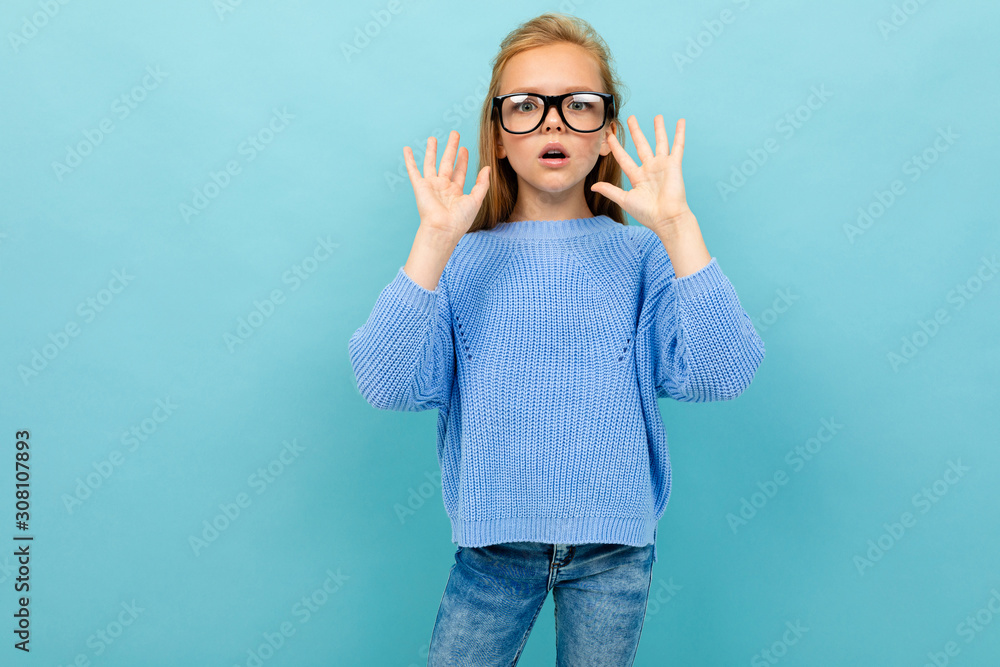 surprised european girl in glasses on a light blue background surprised european girl in glasses on a light blue background