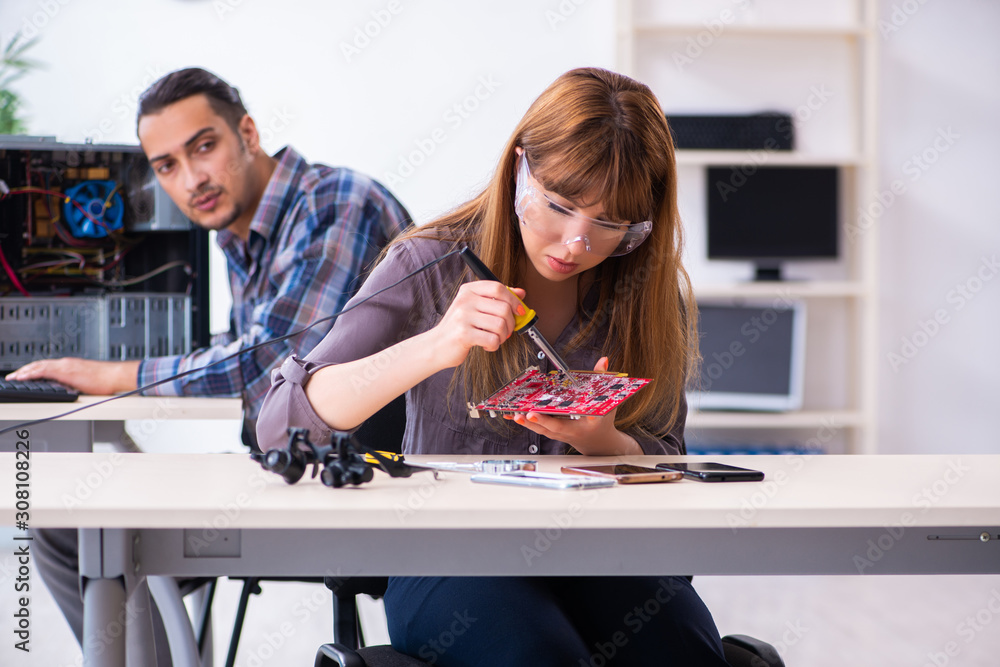 Fototapeta premium Two technicians working at computer warranty center
