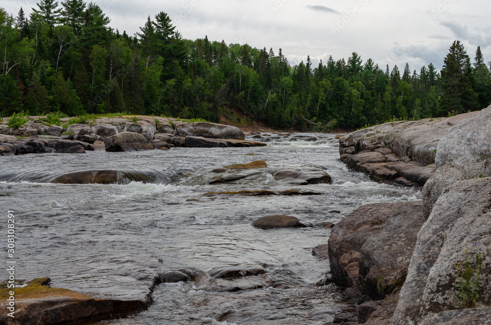 Rapid moving water at Pabineau Falls, New Brunswick, Canada Rapid moving water at Pabineau Falls, New Brunswick, Canada