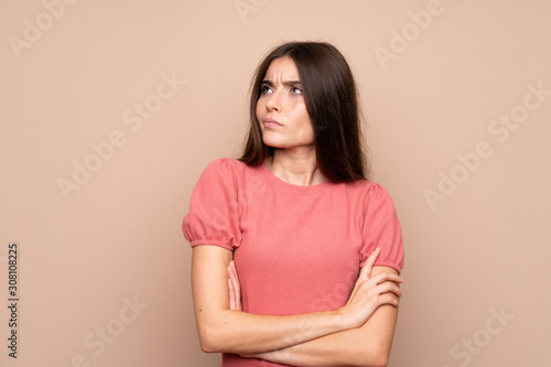 Young woman over isolated background thinking an idea