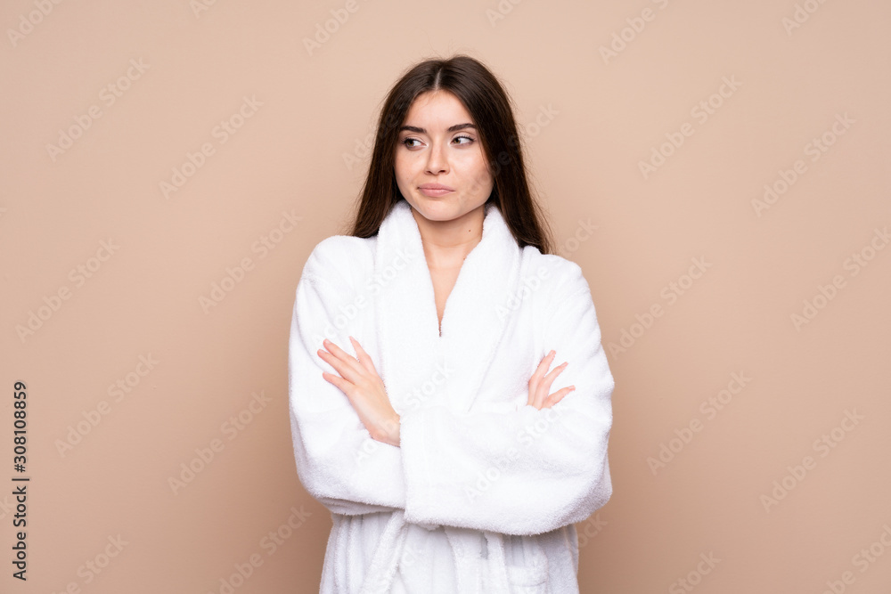 Young girl in a bathrobe over isolated background thinking an idea Young girl in a bathrobe over isolated background thinking an idea