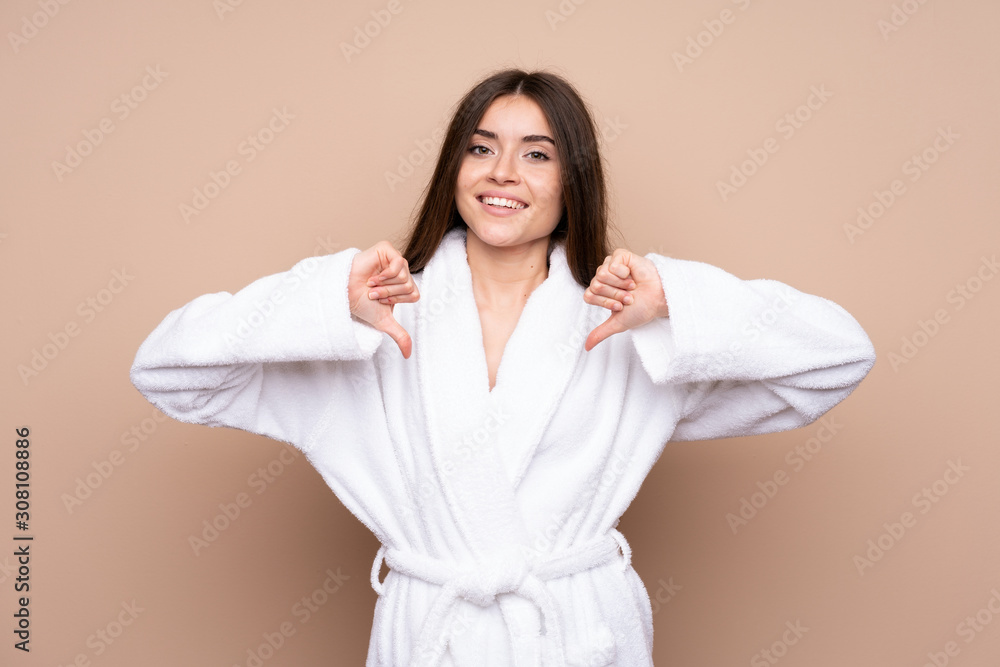 Young girl in a bathrobe over isolated background proud and self-satisfied Young girl in a bathrobe over isolated background proud and self-satisfied