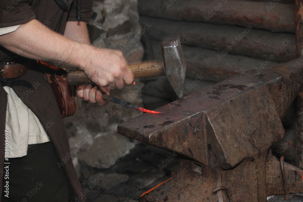 A Blacksmith Models A Bar Of Iron With Hammer After Took It From Fire Forge 
