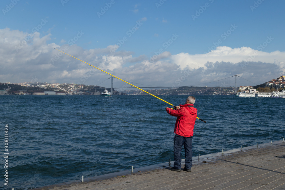 The man is fishing on the Bosphorus from Istanbul. The man is fishing on the Bosphorus from Istanbul.