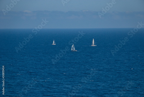 Barcelona, Spain - 18.08.2019: Beautiful white sailing yacht in the blue huge sea