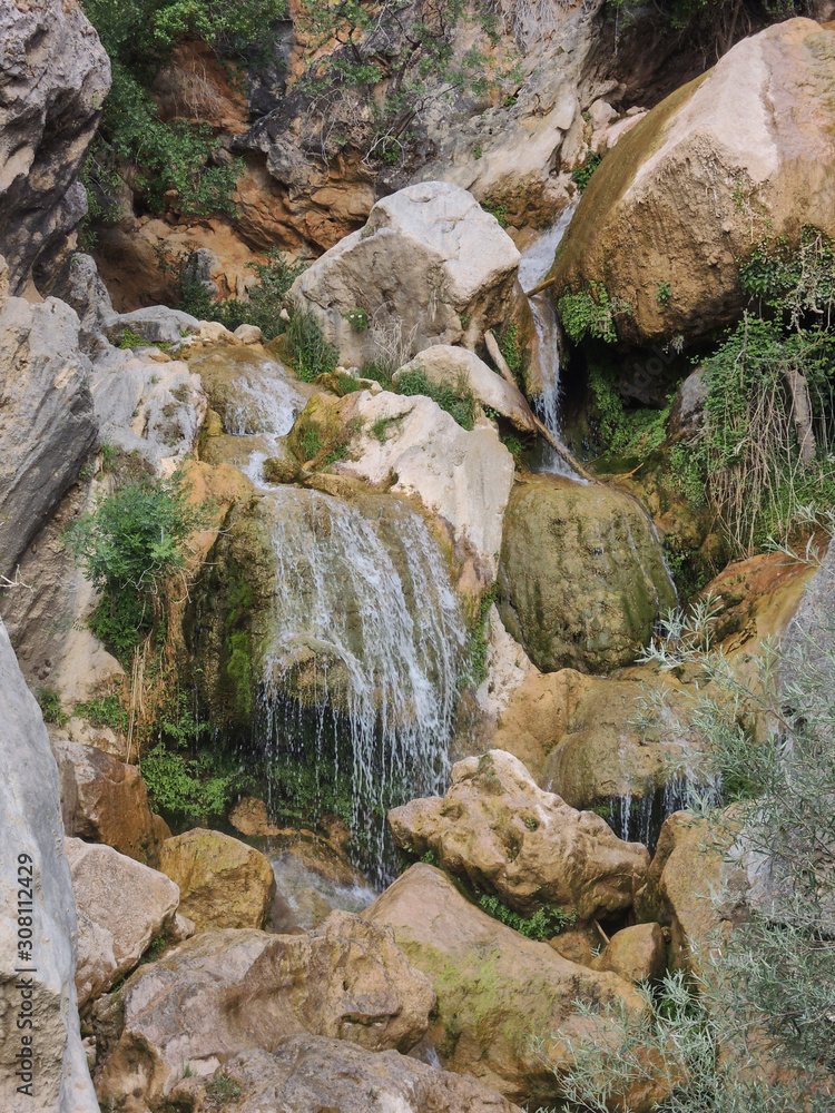 Obraz premium Cascades of the Guadalquivir River as it passes through Cerrada de Utrero in the Natural Park of the Sierra de Cazorla, Segura and Las Villas. In Jaén, Andalusia. Spain