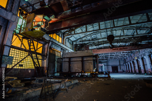 Old broken empty abandoned industrial building interior at night © Mulderphoto