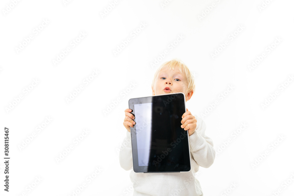 Little blonde caucasian boy shows the tablet isolated on white background Little blonde caucasian boy shows the tablet isolated on white background