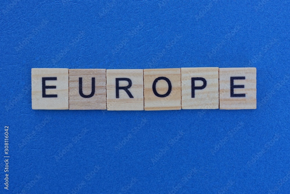 word europe made from wooden gray letters lies on a blue background