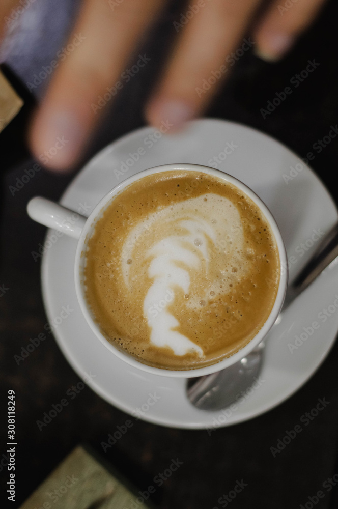 coffee with milk in a white Cup on a black background coffee with milk in a white Cup on a black background
