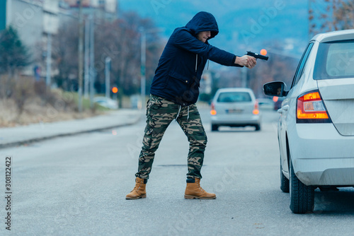 Wallpaper Mural Gangster with a gun trying to rob a guy which is sitting in his car. Torontodigital.ca