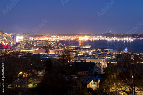 Seattle, Washington, United States. Harbor Island in the Elliott Bay and airplanes taking off and coming in to land nonstop from Seattle airport at night.