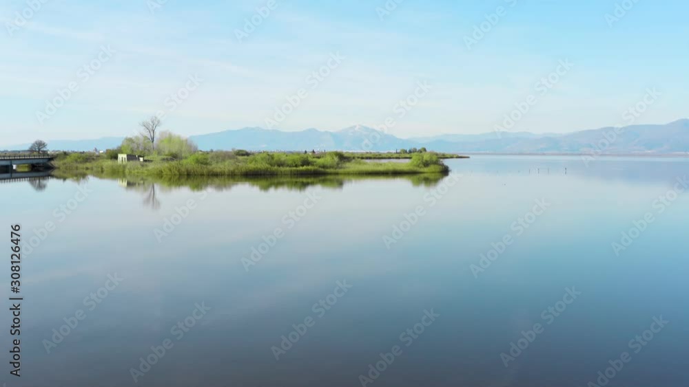 Drone view of flying over lake with shore of green grass, scenic nature landscape. Drone view of flying over lake with shore of green grass, scenic nature landscape.