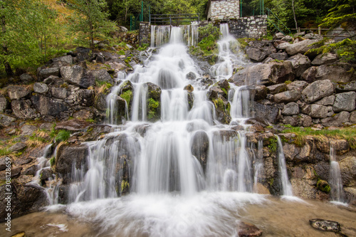A small cascade waterfall  near a village of Encamp  Andorra. Located in the Pyrenees mountain