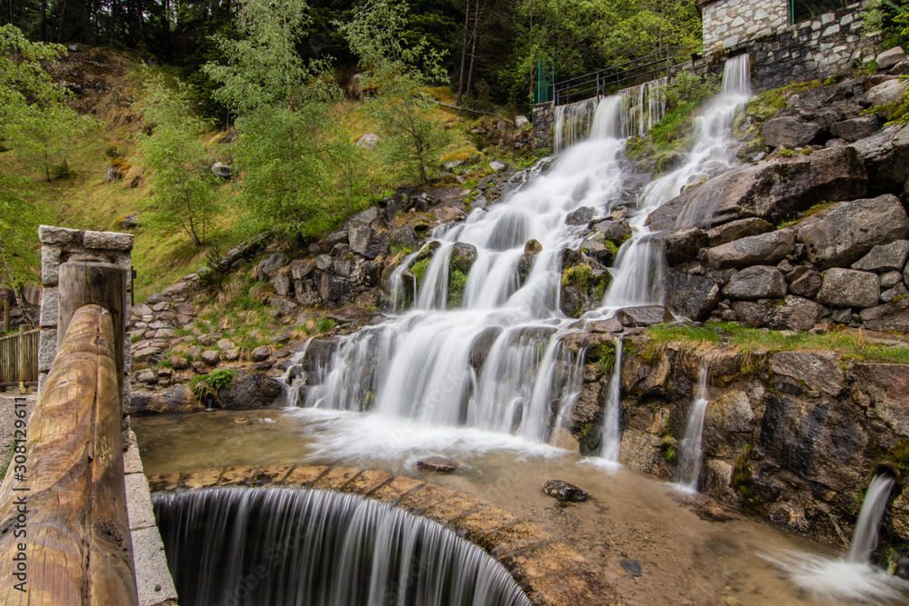 Fototapeta premium A small cascade waterfall, near a village of Encamp, Andorra. Located in the Pyrenees mountain