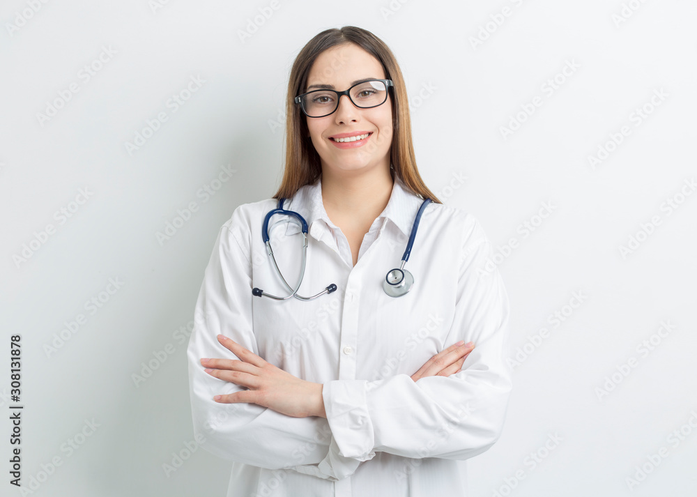 Portrait of a friendly young female professional doctor in a white medical coat. Portrait of a friendly young female professional doctor in a white medical coat.