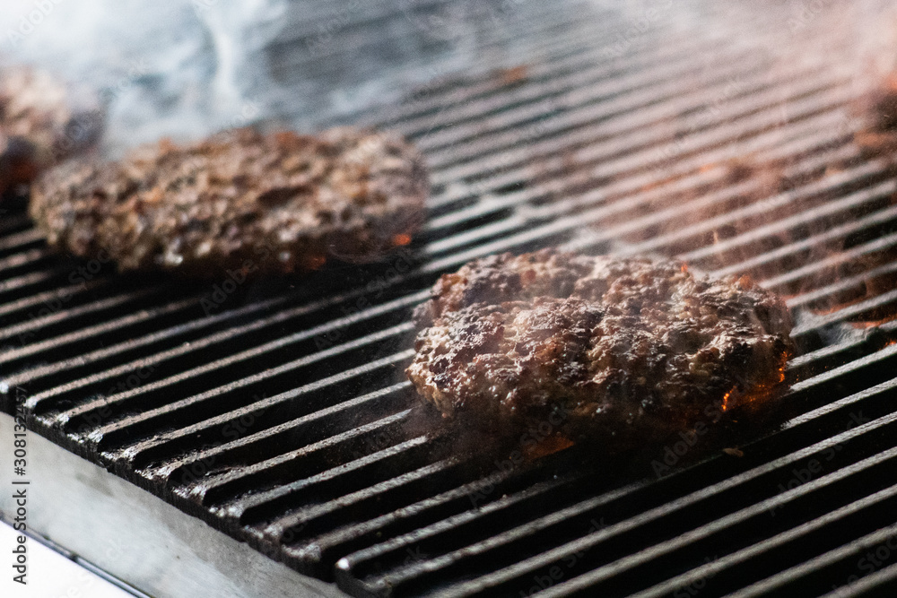 cooking burgers on hot grill with flames cooking burgers on hot grill with flames