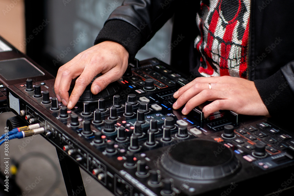 DJ CD player and mixer. DJ Spinning, Mixing, and Scratching, close up DJ CD player and mixer. DJ Spinning, Mixing, and Scratching, close up